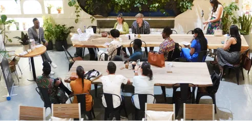 People sitting at an event listening to the speaker